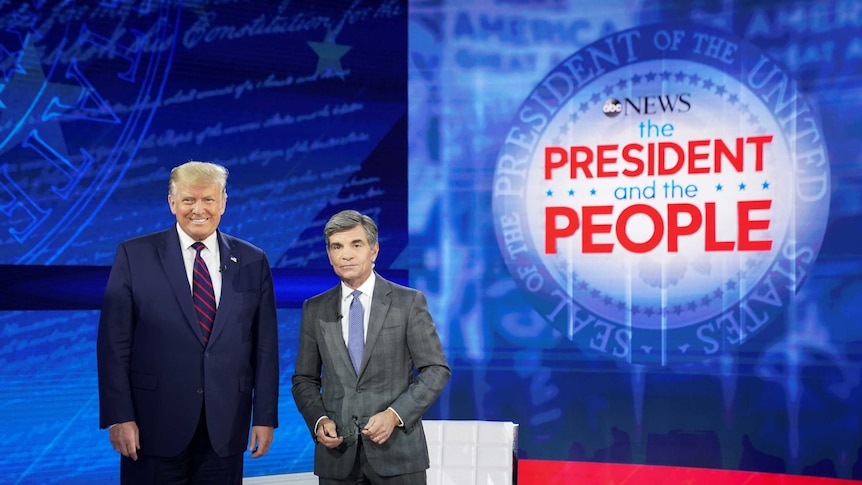 US President Donald Trump takes the stage with ABC News chief anchor George Stephanopoulos