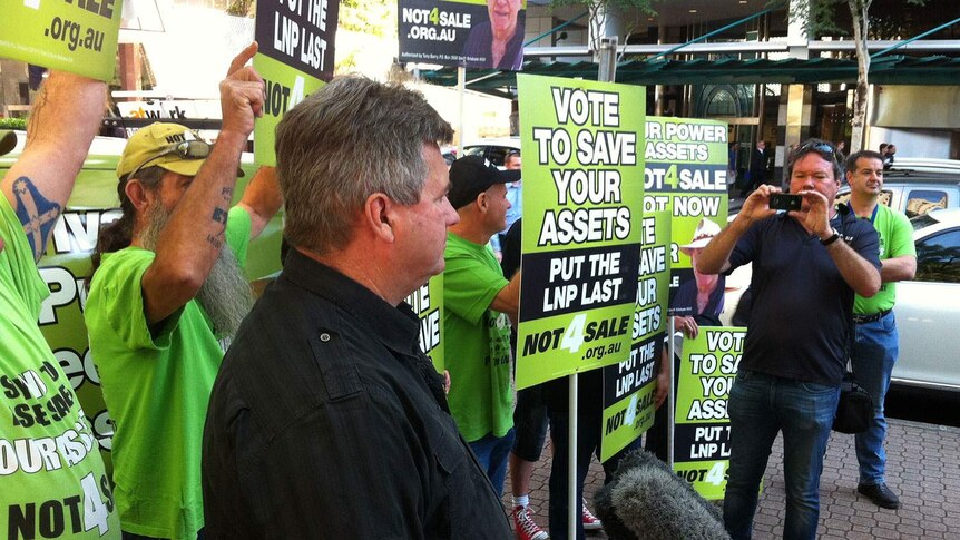 Electrical Trades Union secretary Peter Simpson with protesters outside the Government executive building in Brisbane.