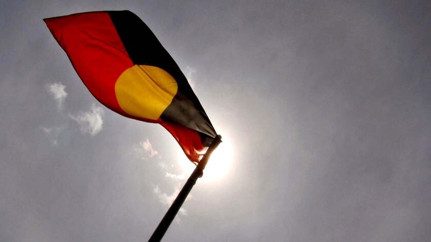 The Aboriginal flag flies in the air.