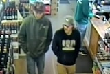 A young man in a bottleshop wearing a grey cap.