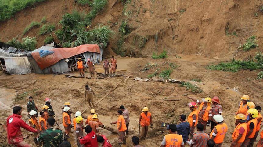 Bangladeshi fire fighters search for bodies after a landslide in Chittagong.