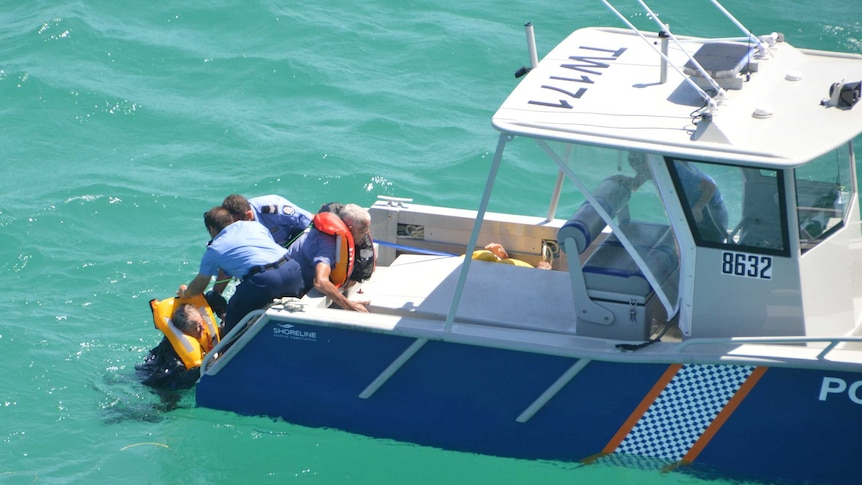 Three men were rescued after spending the night in water off the WA coast.