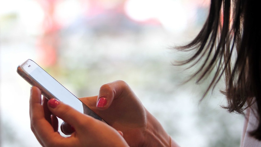 A close up of a woman's hands holding a mobile phone.