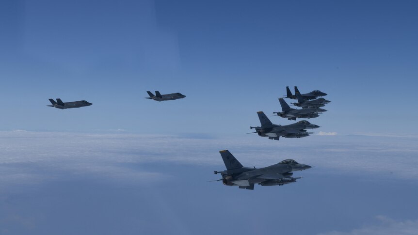 Jet fighters from US and South Korea conduct a formation flight during a joint military exercise