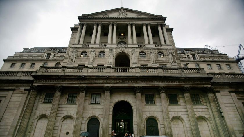 City workers make their way past the Bank Of England in central London