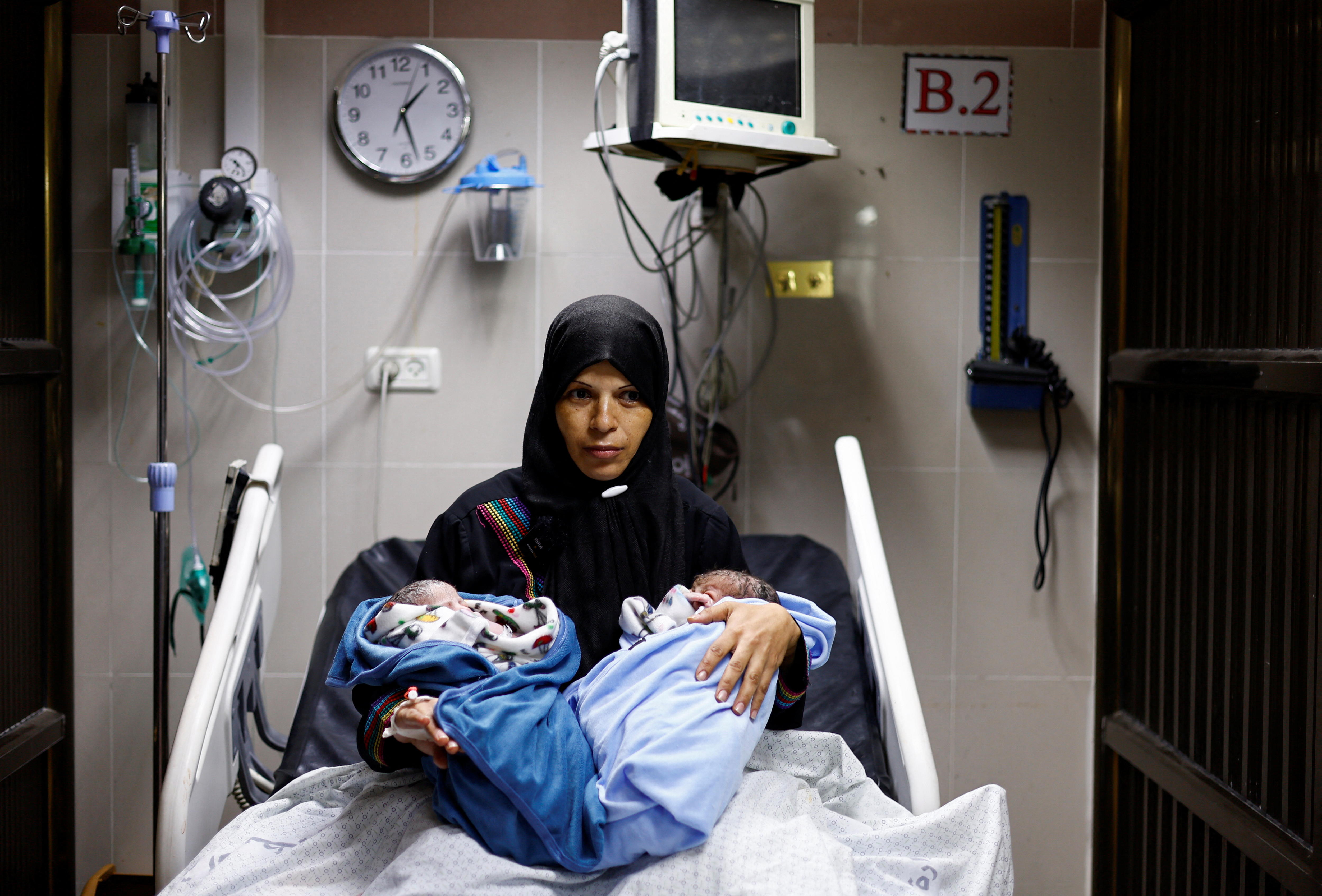Palestinian woman Iman holds her newborn twins Uday and Hamza Abu Odah at Nasser hospital.