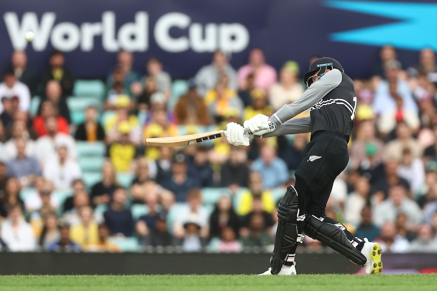 Finn Allen plays a shot with his bat straight out in front of him, parallel to the ground, as seen from side on