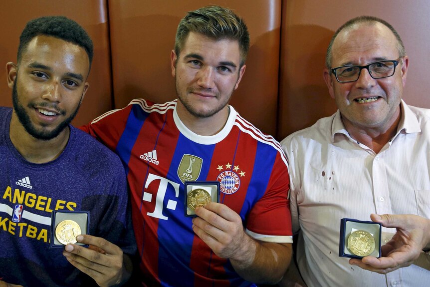 (L-R) Anthony Sadler, Aleck Sharlatos and Chris Norman pose with medals they received for their bravery.