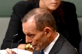Tony Abbott walks past Peta Credlin in the House of Representatives chember.