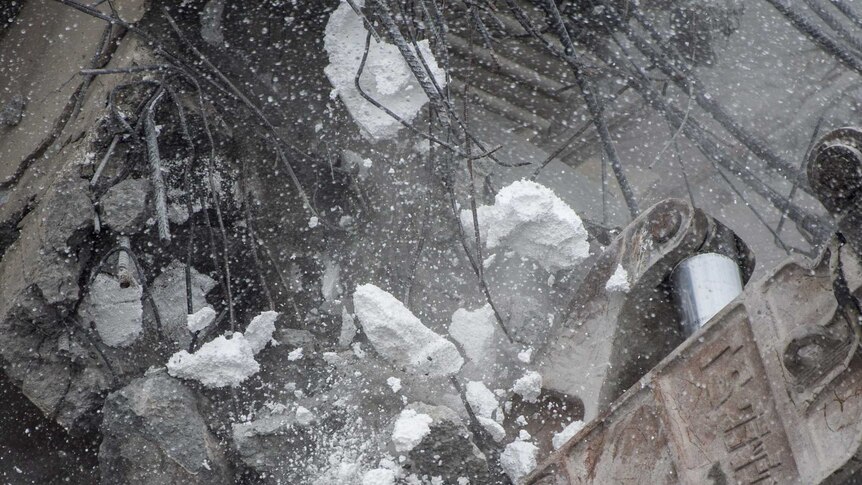 Polystyrene tumbles from walls of collapsed building