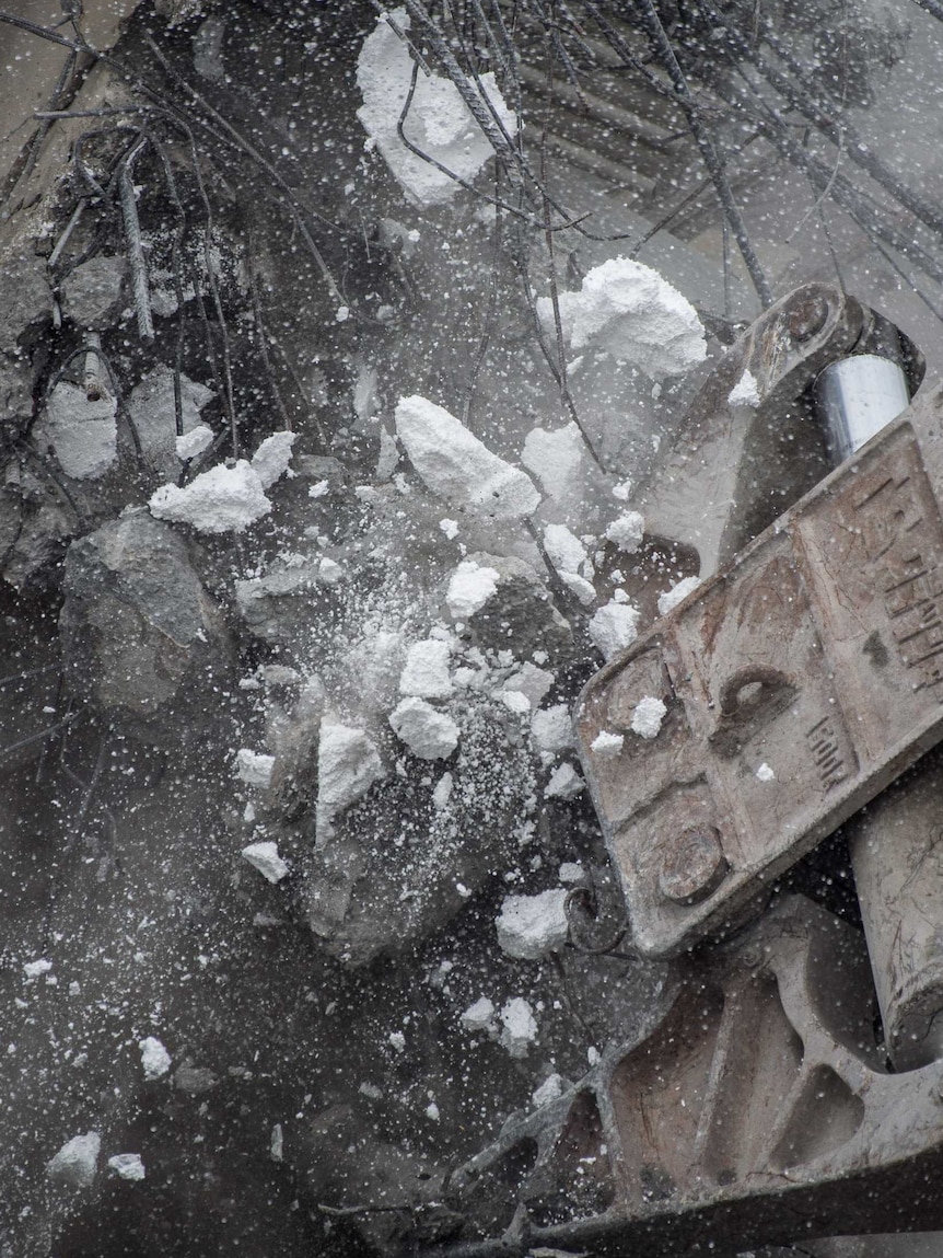 Polystyrene tumbles from walls of collapsed building