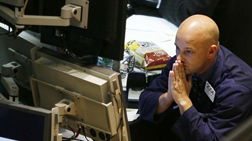 A trader works on the floor of the New York Stock Exchange on September 17, 2008, as Wall Street tumbled to a three-year low.