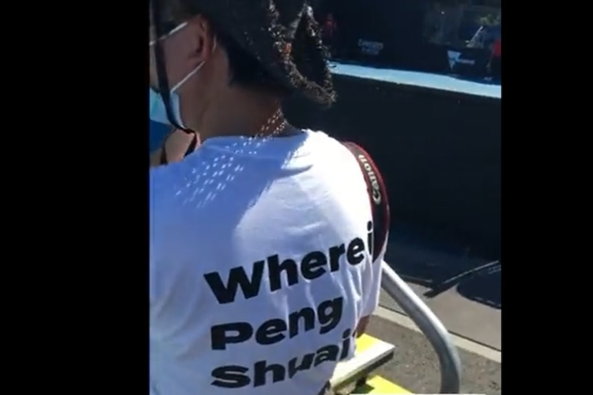 A video still shows a woman wearing a T-shirt reading 'Where is Peng Shuai?'