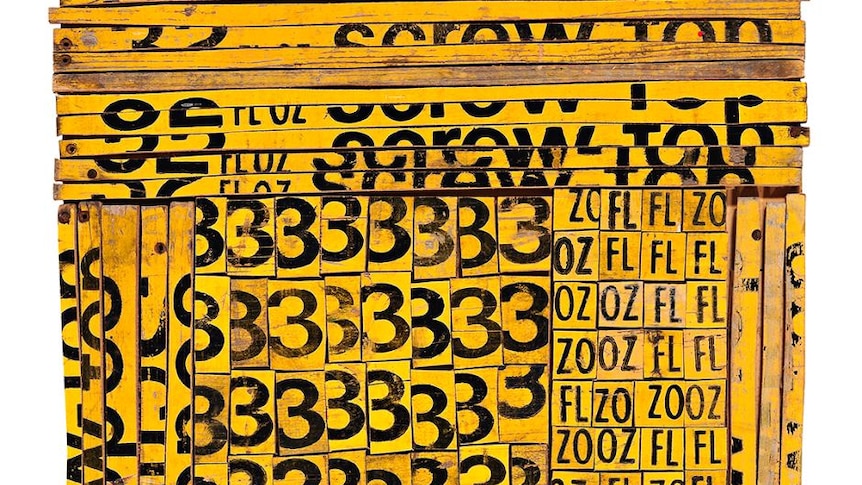 Yellow soft drink crates split and assembled onto plywood to create a colourful collage