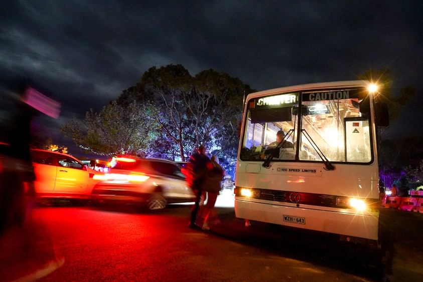 A bus lines up outside the venue to take people to their accommodation.