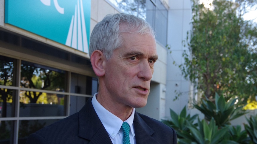 Custodial Inspector Neil Morgan in a suit and tie outside the DCS offices.