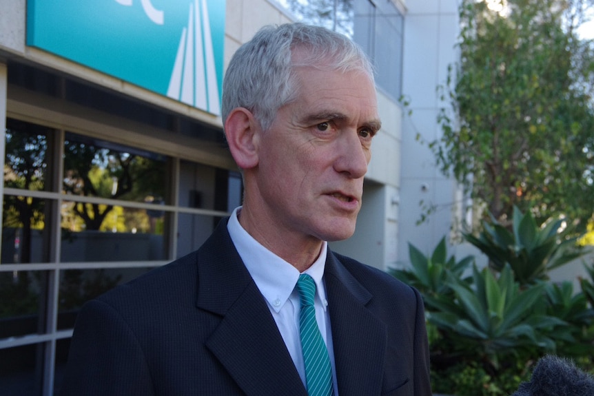 Custodial Inspector Neil Morgan in a suit and tie outside the DCS offices.