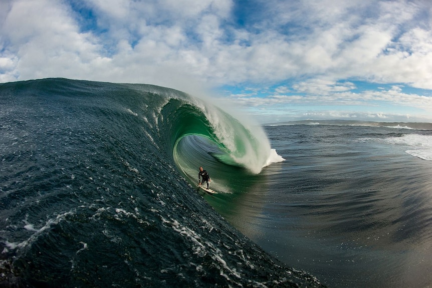 A surfer on a large ocean wave