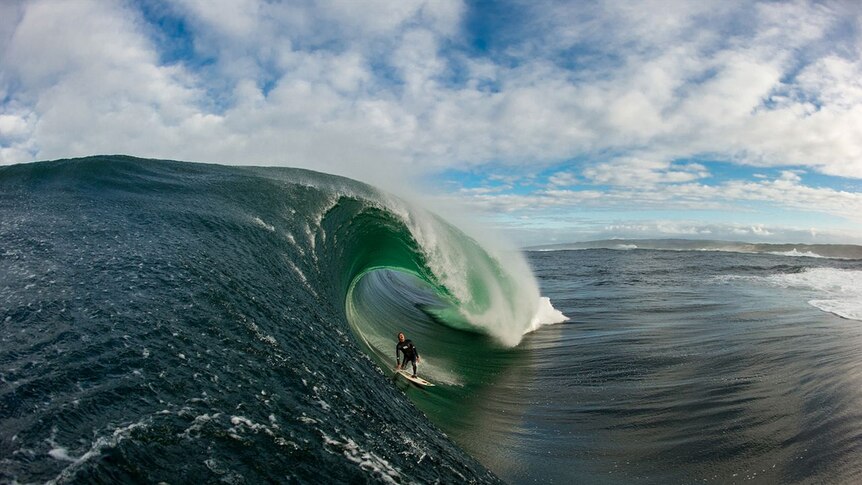 A surfer on a large ocean wave