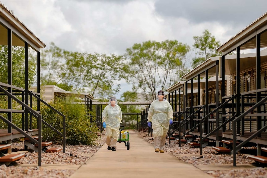 Specialist staff at the Howard Springs facility wear heavy PPE gear.