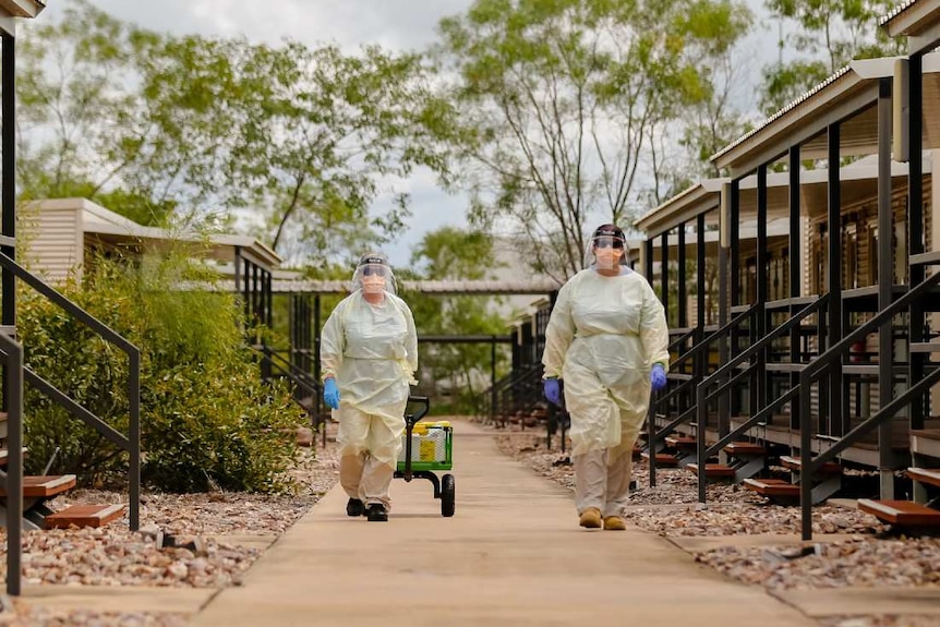 Specialist staff at the Howard Springs facility wear heavy PPE gear.