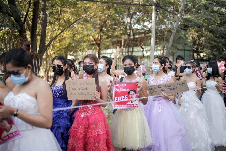 Women wearing ball gowns protest against the military coup in Yangon