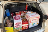 Cartons of liquor stashed in the boot of a white car