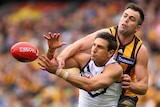 Fremantle's Matthew Pavlich and Hawthorn's Brian Lake contest for a mark during the AFL grand final.