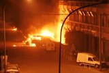 A view shows vehicles on fire outside the Splendid Hotel in Ouagadougou.