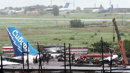 Rescuers at site of a plane crash at a Siberian airport, killing nearly 150 people.