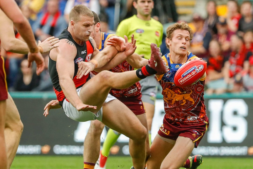 Essendon's Jake Stringer kicks for goal against Brisbane