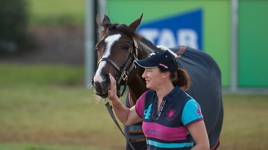 Sarah Denniff gives Snow Sky a pat during training in Victoria.