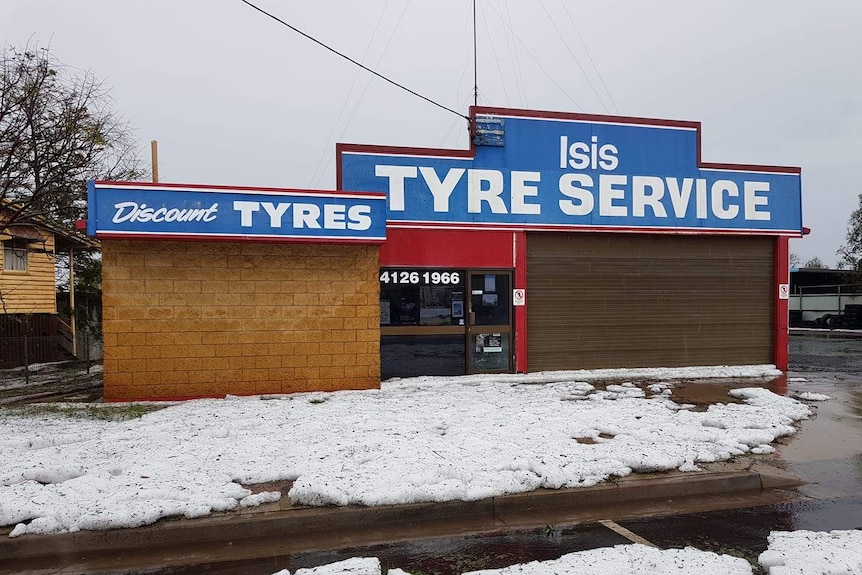 Hail covers street outside a tyre store