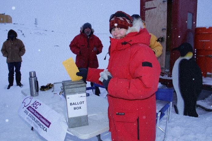 A expeditioner with the Australian Antarctic Division casts her vote