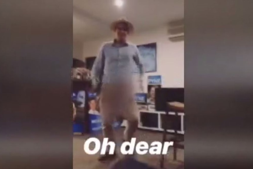 A blurred video show a young man with a phallic object down his pants in front of LNP signage.