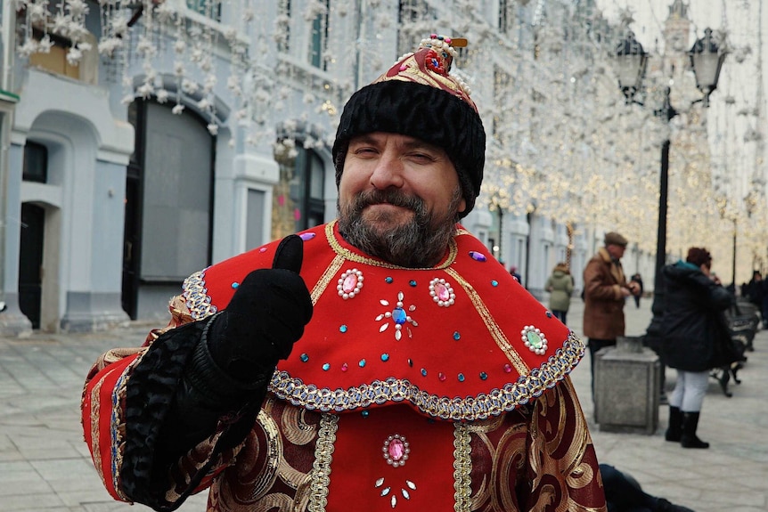 Vasily Ivanov gives a thumbs up as he is dressed as ivan the terrible.