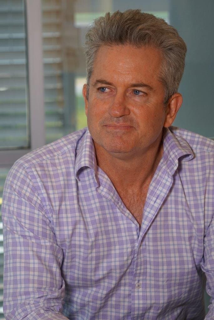 Matthew Grant sits in a room and looks to the left of the camera