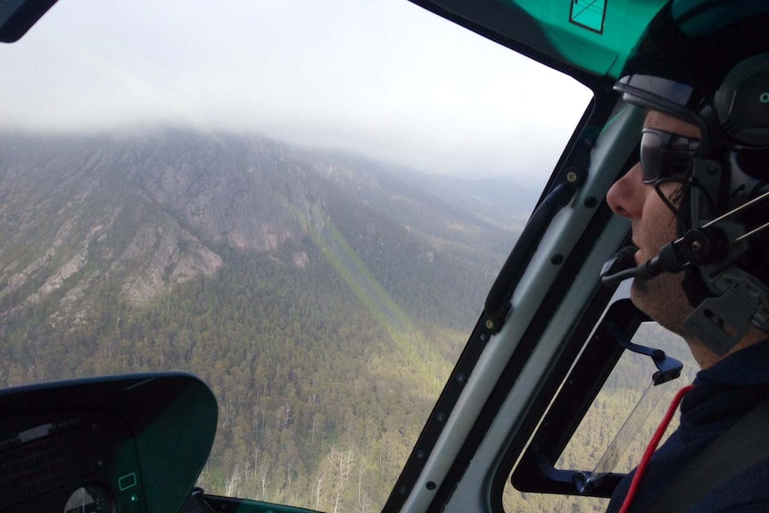 A helicopter pilot flies into Pelion Hut on Tasmania's Overland Track.