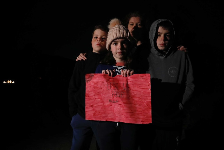 A mother, her two sons and a daughter in their driveway on Anzac Day.