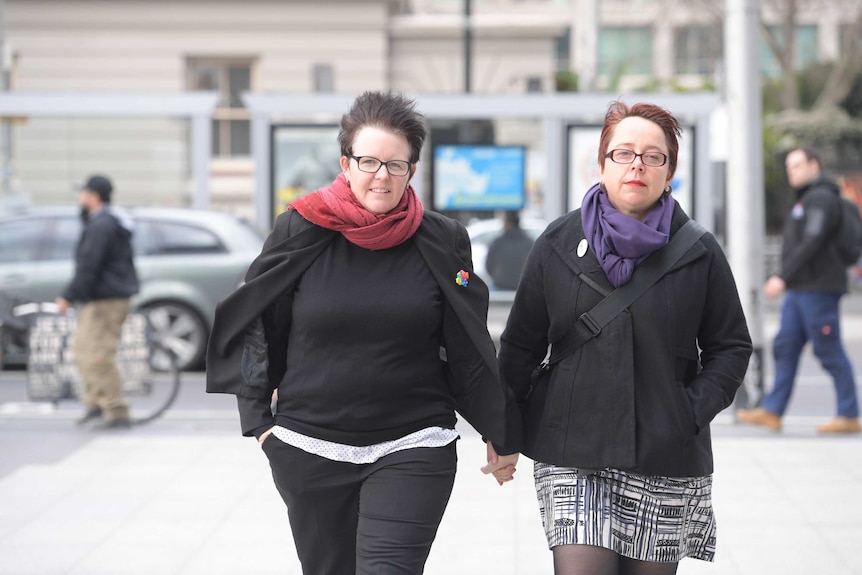 Felicity Marlowe and her partner Sarah Marlowe stand outside court in Melbourne.