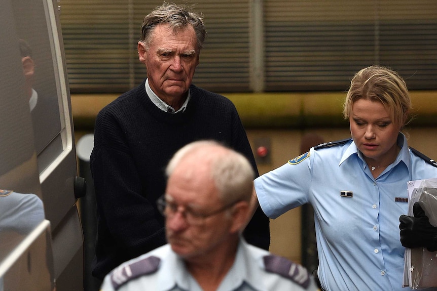 Police lead Ian Turnbull into a van.