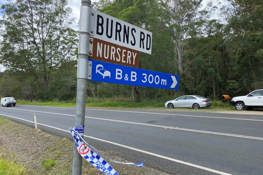Road sign with police tape