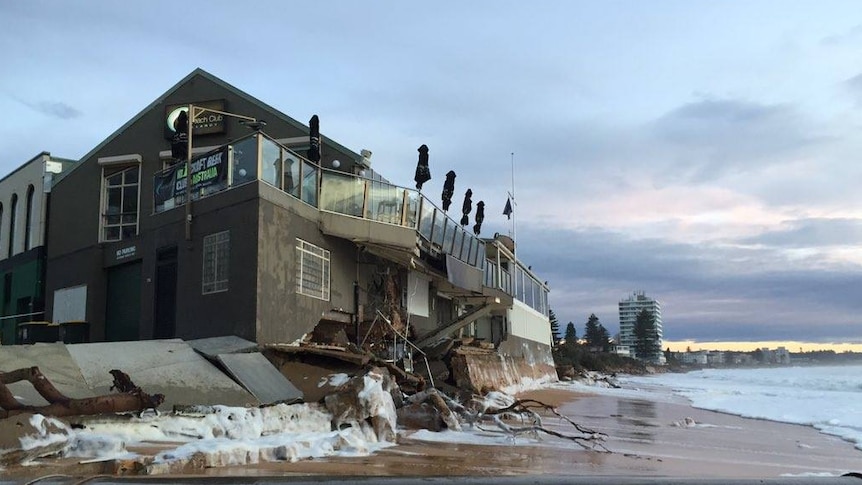 Debris and foam piled up against the beach club.