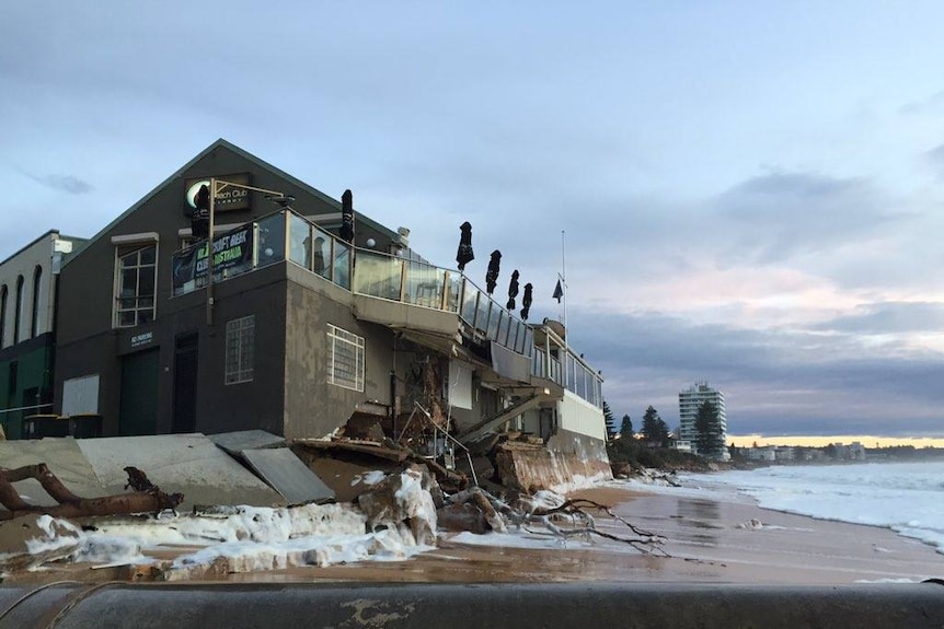 Debris and foam piled up against the beach club.