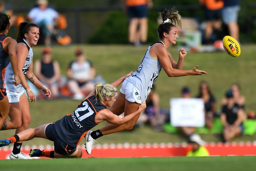 Nicola Stevens of the Blues is tackled by Yvonne Bonner of the Giants in the AFLW.