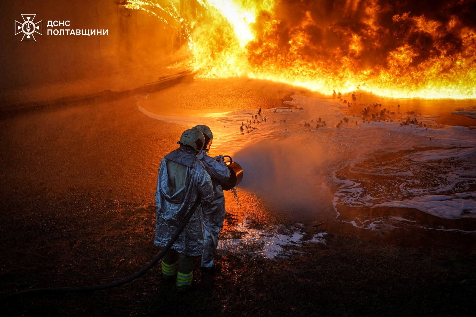 Firefighters work at a site of a Russian missile and drone strike.