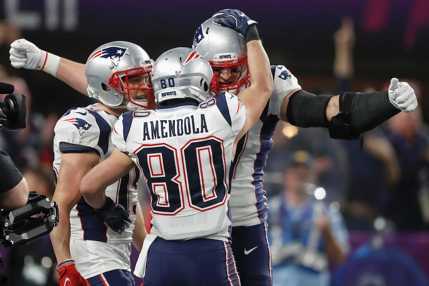 New England Patriots' Rob Gronkowski, rear, celebrates a touchdown in Super Bowl LII.