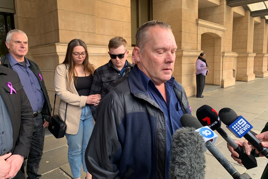 A man speaks to the media outside court.