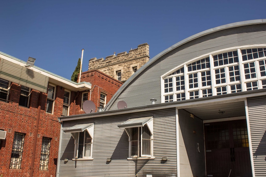 The original 1896 Swan Barracks drill hall sits behind the street front.