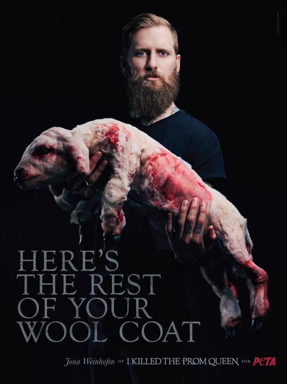 A musician holding up a bloodied lamb.